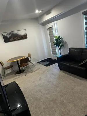 a living room with a couch and a table at Praise bethel -Homely walkout legal basement in YYC in Calgary