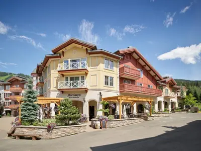 a large apartment building in the middle of a parking lot at Residences at the Sun Peaks Grand in Sun Peaks
