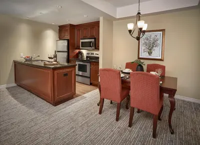 a kitchen and dining room with a table and chairs at Residences at the Sun Peaks Grand in Sun Peaks