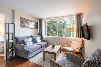a living room with a couch and a table at The Après Suite in Whistler