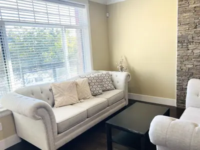 a living room with a couch and a window at Jennifer's House in Vancouver