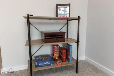 a book shelf with a radio and books at Orchards Retreat, AC, Family Friendly, Sleeps 10, NearAirprt in Nisku