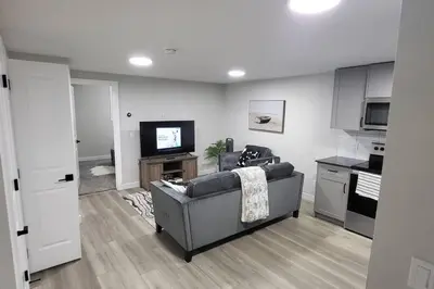 a living room with a couch and a tv at Serene Haven - 1 bedroom apartment. in Calgary