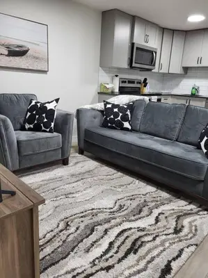a living room with a couch and a rug at Serene Haven - 1 bedroom apartment. in Calgary
