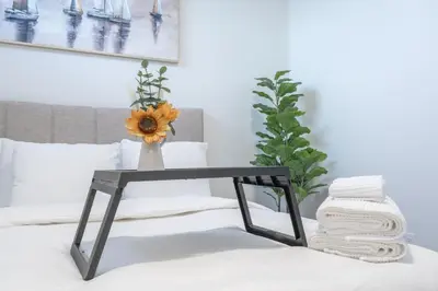 a black table with a vase on top of a bed at Stylish Getaway 2BD Basement by YMCA and South Health Campus Hospital in Calgary