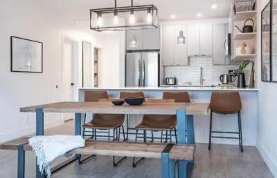 a kitchen with a wooden table and chairs at Glades and Greens by Revelstoke Vacations in Revelstoke