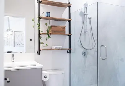 a bathroom with a shower and a toilet and a sink at Glades and Greens by Revelstoke Vacations in Revelstoke
