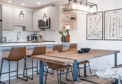 a kitchen with a wooden table and chairs at Glades and Greens by Revelstoke Vacations in Revelstoke