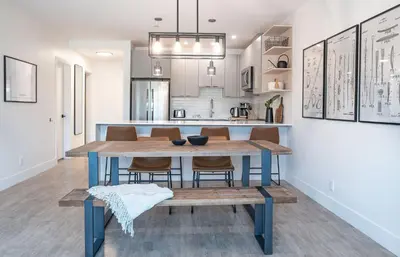 a dining room and kitchen with a table and chairs at Glades and Greens by Revelstoke Vacations in Revelstoke