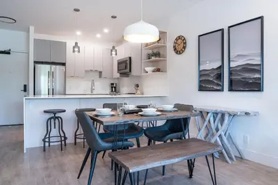 a kitchen and dining room with a table and chairs at Slopes and Greens by Revelstoke Vacations in Revelstoke