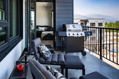 a grill on the balcony of a house at Slopes and Greens by Revelstoke Vacations in Revelstoke