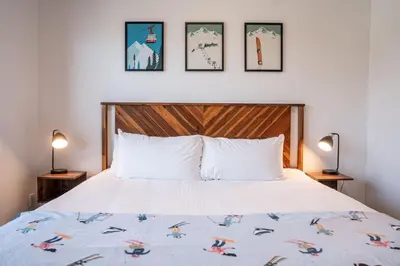 a bedroom with a bed and three pictures on the wall at Slopes and Greens by Revelstoke Vacations in Revelstoke