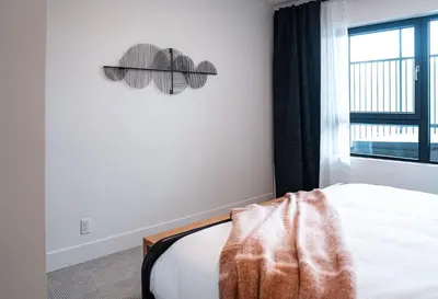 a bedroom with a bed and a window at The Monashee House by Revelstoke Vacations in Revelstoke