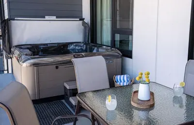 a kitchen with a table and a grill in a room at The Monashee House by Revelstoke Vacations in Revelstoke
