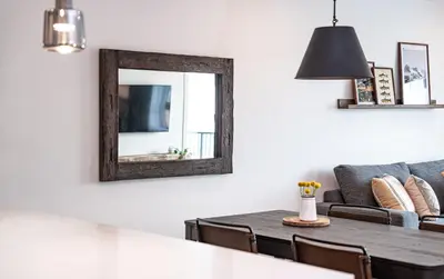 a living room with a mirror and a table at The Selkirk House by Revelstoke Vacations in Revelstoke
