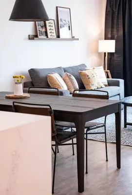 a living room with a table and a couch at The Selkirk House by Revelstoke Vacations in Revelstoke