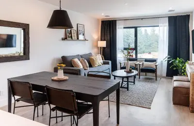 a living room with a table and a couch at The Selkirk House by Revelstoke Vacations in Revelstoke