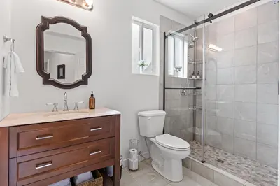 a bathroom with a shower and a toilet and a sink at Private Mountainside Home in Chilliwack