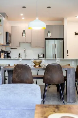 a kitchen with a table and chairs in a room at Revy's Stellar Retreat in Revelstoke