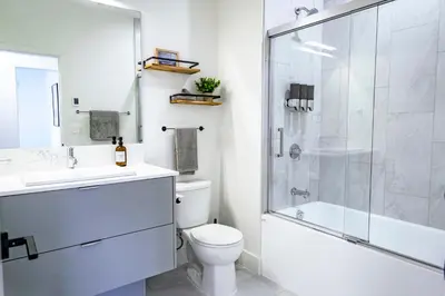 a bathroom with a shower and a toilet and a sink at Revy's Stellar Retreat in Revelstoke