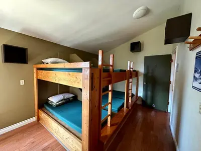 a couple of bunk beds in a room at Canmore Alpine Hostel - Alpine Club of Canada in Canmore