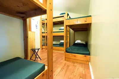 a room with two bunk beds in a cabin at Canmore Alpine Hostel - Alpine Club of Canada in Canmore