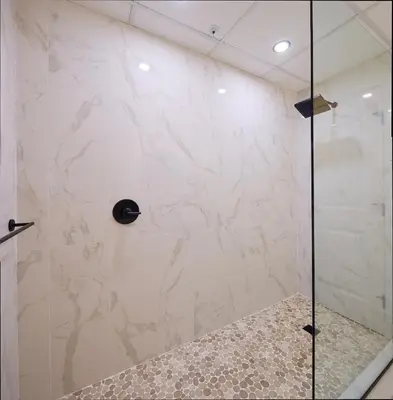 a shower with a glass door in a bathroom at Lakeside Luxe Haven in West Kelowna
