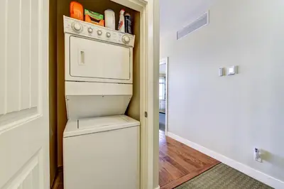a kitchen with a white stove and a refrigerator at Lakeside Luxe Haven in West Kelowna