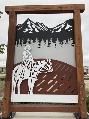 a sign with a person riding a giraffe at Rocky Mountain View Bed & Breakfast in Cochrane