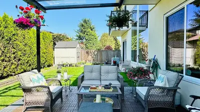 a patio with a couch and chairs and a table at Quiet Room in Richmond in Richmond