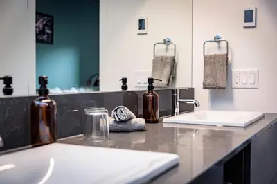 a bathroom counter with two sinks and a mirror at The Three Bear Penthouse - with Hot Tub in Revelstoke