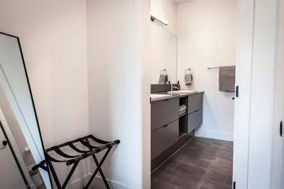 a small kitchen with a sink and a chair at The Three Bear Penthouse - with Hot Tub in Revelstoke