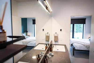 a bathroom with two beds and a sink in a room at The Three Bear Penthouse - with Hot Tub in Revelstoke