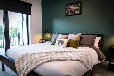 a bedroom with a large bed with pillows at The Three Bear Penthouse - with Hot Tub in Revelstoke