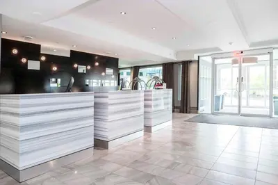a kitchen with white counter tops in a building at Sandman Signature Kamloops Hotel in Kamloops