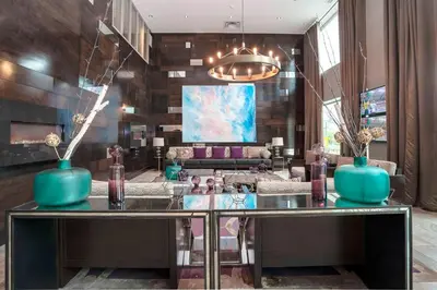 a lobby with a glass table with vases on it at Sandman Signature Kamloops Hotel in Kamloops