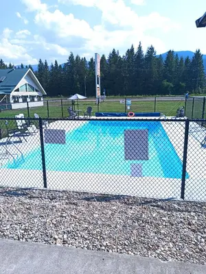 a fence around a swimming pool in a park at Clearwater Country Inn in Clearwater