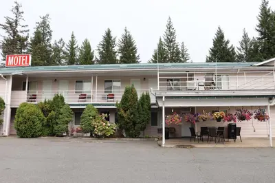 a motel with a table and chairs in front of it at Clearwater Country Inn in Clearwater