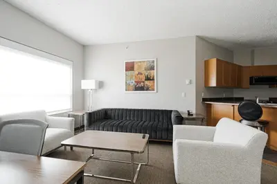 a living room with a couch and chairs and a table at Premier Residence - Fort McMurray in Fort McMurray
