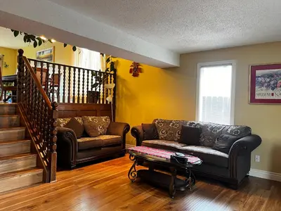 a living room with a couch and a table at Beautiful room close Airport! in Calgary