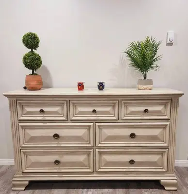 a dresser with two potted plants on top of it at Comfort First - sleeps 6 in Whitehorse