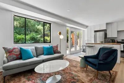 a living room with a couch and a table at Mid-Century Modern Dream Retreat in West Kelowna