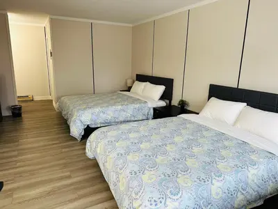 a hotel room with two beds in a room at City Centre Motel II in Hope