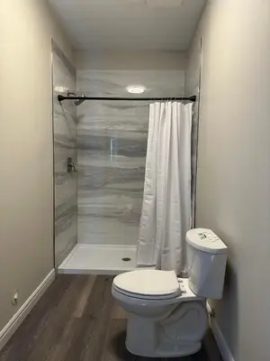 a bathroom with a toilet and a shower at City Centre Motel II in Hope