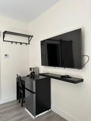 a large flat screen tv hanging on a wall at City Centre Motel II in Hope
