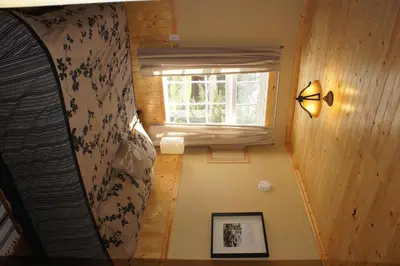 a small room with a bed and a window at Fairmont Mountain Bungalows in Fairmont Hot Springs
