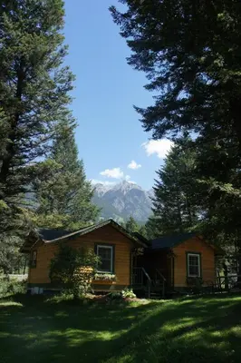 a log cabin with a view of a mountain at Fairmont Mountain Bungalows in Fairmont Hot Springs