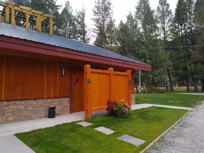 a building with a wooden door on the side of it at Fairmont Mountain Bungalows in Fairmont Hot Springs