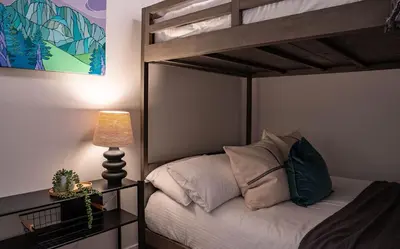 a bedroom with a bunk bed with a lamp at Galena by Revelstoke Vacations in Revelstoke