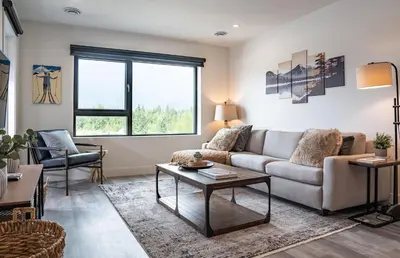 a living room with a couch and a table at Revylation by Revelstoke Vacations in Revelstoke